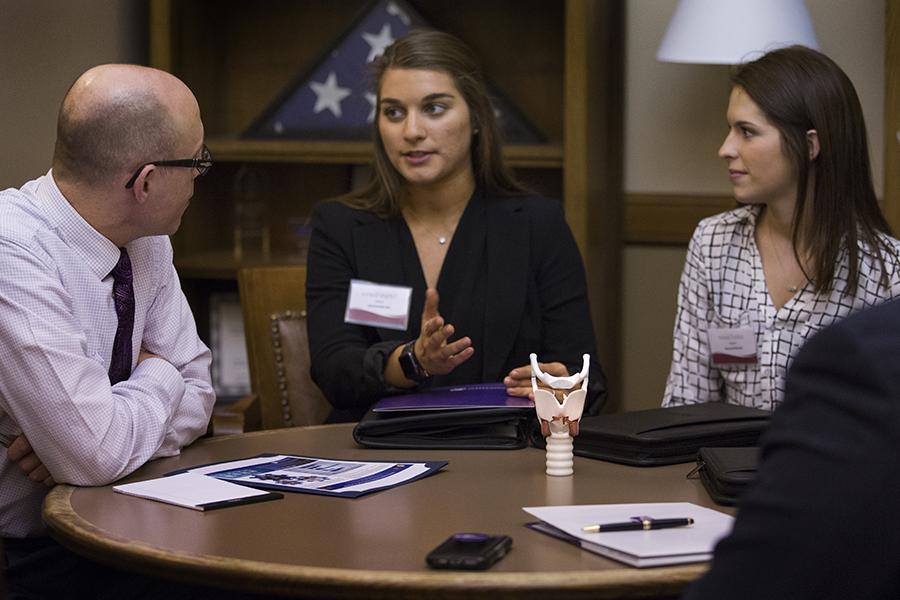 Two students speak with a Wisconsin State Representative.